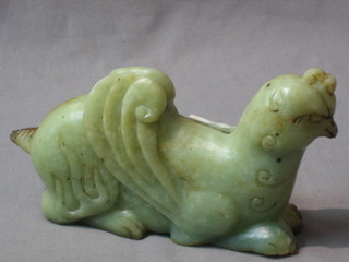 A carved jade coloured figure of a mythical beast 7"