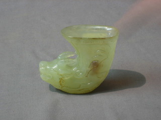 A carved jade coloured cup in the form of a mythical beasts head 3"