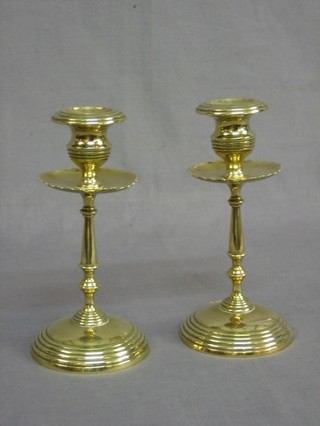 A pair of 19th Century brass candlesticks with circular shaped sconces 7"
