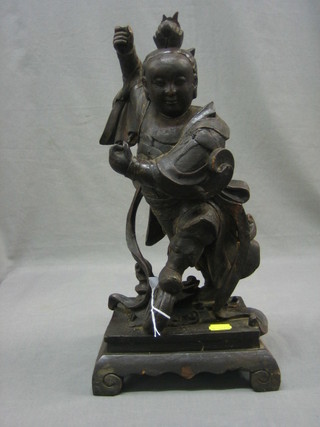 An Eastern carved figure of a standing warrior  16"
