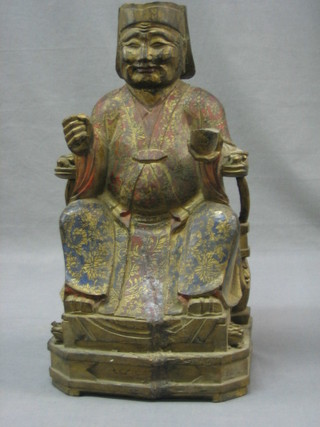 A carved and painted figure of a seated Eastern Deity 13"
