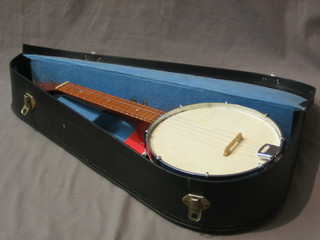 A four stringed Fornby Ukulele banjo, cased
