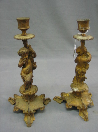 A pair of Victorian gilt painted candlesticks decorated Bacchanalian figures 12"