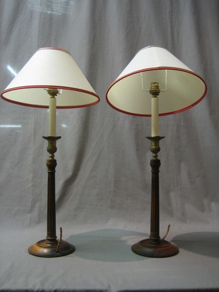 A pair of turned and fluted oak table lamps with gilt metal sconces 14"