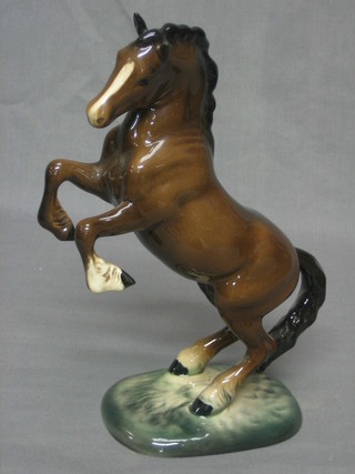 A Beswick figure of a rearing bay horse, raised on oval base, base impressed Beswick England 1014, 10"