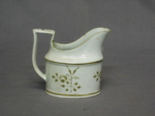 A 19th Century cream glazed jug with floral decoration (chip to spout) 3"