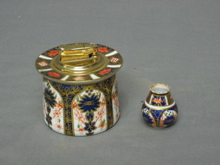 A Royal Crown Derby cylindrical porcelain table lighter, the base marked XX1X, 2 1/2" together with a miniature Royal Crown Derby vase, 1" (2)