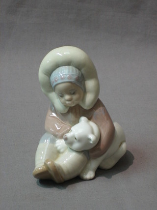 A Lladro figure in the form of an Eskimo with polar bear, the base marked Lladro 5"