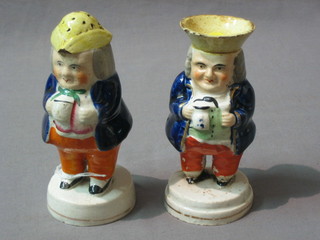 A Staffordshire salt and pepper in the form of Toby Philpot standing (salt f and r)