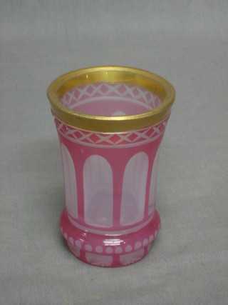 A Bohemian pink glass beaker with faceted decoration  4"