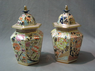 A pair of Nathan's limited edition hexagonal yellow Siam pattern urns and covers 10"