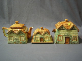 A Keele Street Pottery cheese dish and cover in the form of a cottage 6" and a Cottageware teapot and biscuit barrel