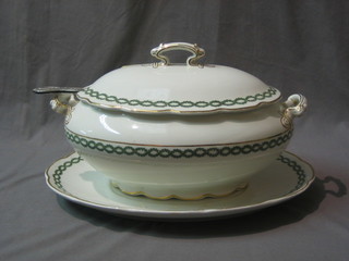 A Crescent china white oval pottery sauce tureen and cover with gilt banding and garland decoration together with a matching stand and a silver plated Kings Pattern ladle