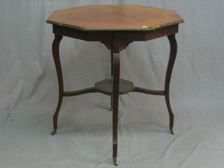 An Edwardian octagonal mahogany occasional table, raised on cabriole supports 27"