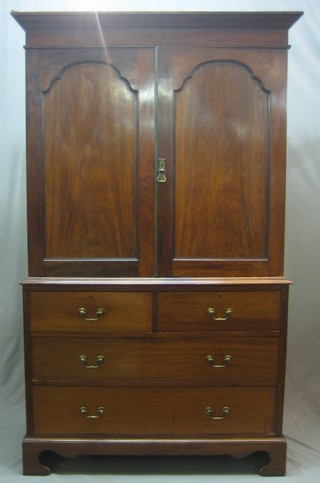 A Victorian mahogany linen press with moulded cornice, the interior fitted trays enclosed by arch shaped panelled doors, the base fitted 2 short and 2 long drawers, raised on bracket feet 48"