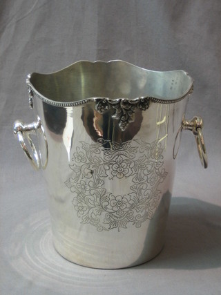 A circular silver plated wine cooler with circular ring drop handles and carved vinery decoration 8"