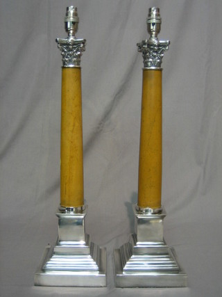A pair of silver plated and marble finished table lamps, raised on stepped bases with Corinthian capitals 20"