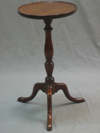 A circular Georgian style mahogany wine table, raised on pillar and tripod supports 11"