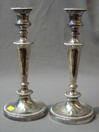 A pair of silver plated candlesticks with detachable sconces and beadwork border 11 1/2"