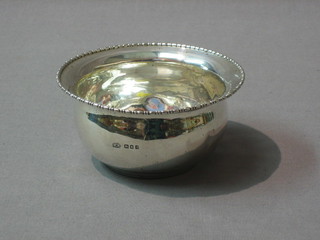 A circular silver sugar bowl, London 1922 by Mappin & Webb, 3 ozs (some dents)