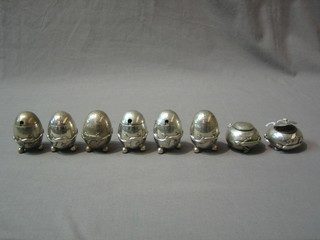 An Eastern condiment set of oval form comprising a silver squat mustard and pepper, 3 "silver" pepper pots and 3 "silver" mustard pots and 2 "silver" salt pots,