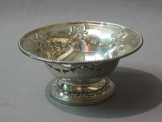 A circular embossed silver pedestal bowl with garland decoration, Sheffield 1907, by Walker & Hall, 6 ozs