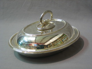 An oval silver plated entree dish and cover with bead work border by Mappin Bros