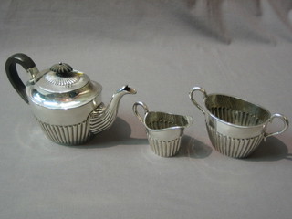 A 3 piece oval Britannia metal bachelors tea service with demi-reeded decoration comprising teapot, milk jug and sugar bowl