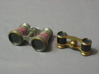 A pair of French 19th Century metal and pink enamel opera glasses (f) and a pair of gilt metal opera glasses