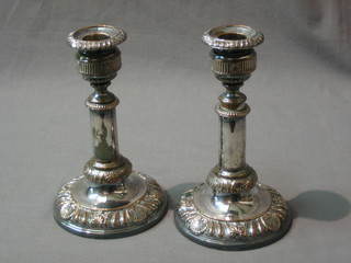 A good pair of 19th Century Sheffield plate adjustable candlesticks with gadrooned decoration