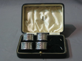 4 engraved silver plated napkin rings, cased
