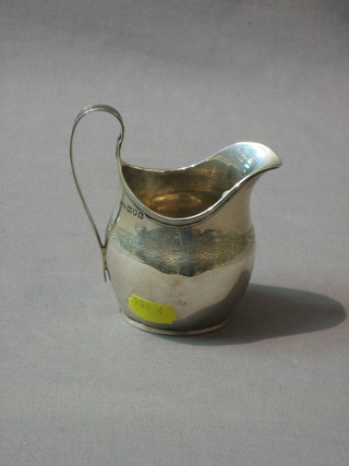 A Georgian style silver cream jug with engraved decoration, London 1913, 3 ozs