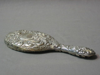 An embossed silver backed handmirror