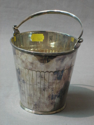 A circular silver plated ice pail