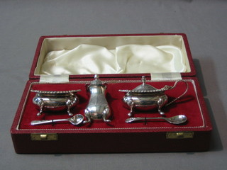 A Georgian style oval silver plated 3 piece condiment set comprising mustard, salt and pepper pot, cased