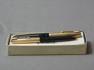 A Parker 51 fountain pen contained in a gold plated case and a similar ballpoint pen