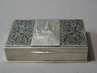 An Eastern silver rectangular cigarette box with hinged with embossed Niello decoration, the reverse marked Sterling 925, slight dent to lid, 6 1/2"