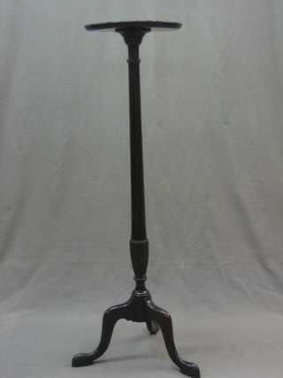 A Chippendale style circular mahogany torchere raised on pillar and tripod supports 11"