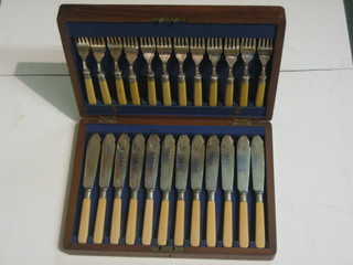 A set of 12 silver plated fish knives and forks in an oak canteen box