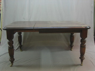 A Victorian style mahogany extending dining table with 1 extra leaf, raised on turned supports 58"