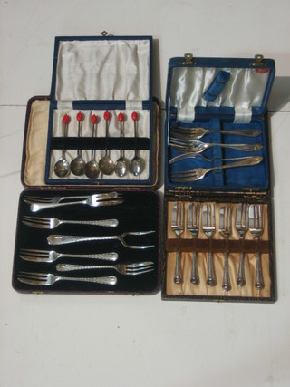3 sets of 6 silver plated fruit forks, cased, a set of 6 silver plated bean end coffee spoons