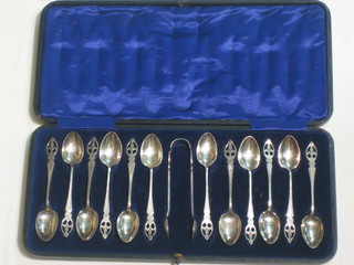 12 silver plated tea spoons complete with tongs, cased