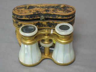 A pair of French gilt metal and mother of pearl opera glasses (1 eye piece missing)