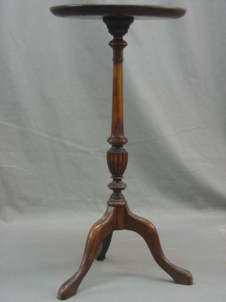 An Edwardian circular inlaid mahogany wine table raised on pillar and tripod supports