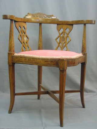 A Victorian carved walnut corner chair with upholstered seat raised on square tapering supports