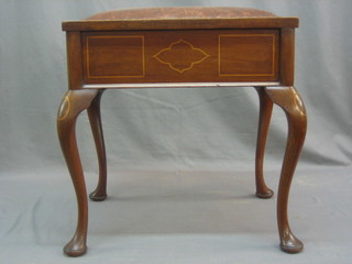 An Edwardian box seat piano stool with hinged lid, raised on cabriole supports 19"