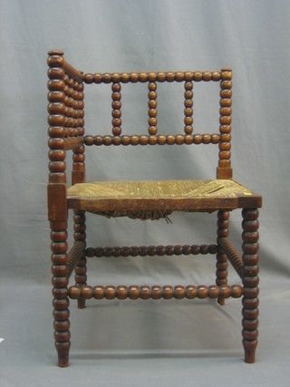 A 19th Century oak corner chair with bobbin turned decoration