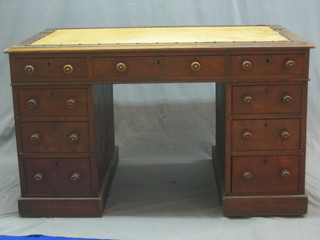 A Victorian oak kneehole pedestal desk, the top fitted 2 brass candle stands above 1 long and 8 short drawers, 48"