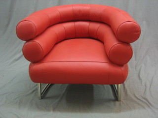 A Bibendum designer chromium plated and red leather tub back chair