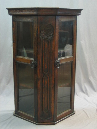 An oak hanging cabinet enclosed by glazed panelled doors 28"